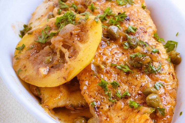 Mix chicken with pepper and salt well. Put the peppers in a bowl, cut them into large rectangles, and set them aside. Put a tablespoon of butter in a saucepan, put the chicken slices on it, and leave it until it is cooked and browned on both sides. Transfer the chicken to another plate. Put the rest of the amount of butter in the same pan, then add the onions, garlic, flour, cardamom, bay leaf, and ginger. Stir the ingredients well to combine. Return the chicken slices to the skillet, then add the olives, mushrooms, and peppers. Pour the water over the ingredients, and leave the mixture on the fire until it boils. Put the cream and milk in a bowl, then mix until well combined. Transfer the chicken piccata to a serving platter, and serve hot