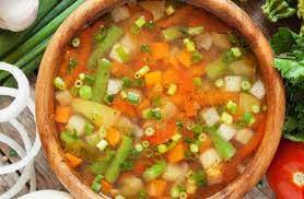 Bring a cooking pot, put olive oil in it, then chopped onions and stir a little until it wilts, then add orzo and my heart until it changes color to golden. Put the chopped garlic on the previous mixture and stir a little, then start putting the vegetables, start with the potatoes and carrots, then put the beans, peas, tomatoes and zucchini. Add spices, salt, pepper and cumin, then add chicken soup or chicken broth and water, and stir the mixture. Cover the pot to simmer the soup over medium heat for 10 to 15 minutes, then remove from the heat and serve hot.