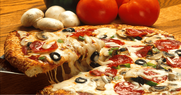 Mix the flour with a pinch of sugar, baking powder, yeast and a pinch of salt * Add the yoghurt and oil and gradually add the water while continuing to knead Leave it to ferment, then roll it out on a floured surface and place on an oiled tray * Add the sauce to half of the dough, then add the pastrami, olives and mozzarella cheese, then close it * Grease the dough with sauce, sprinkle mozzarella cheese on top and put it in the oven How to prepare the sauce * Mix the grated tomatoes with garlic, salt, pepper, oil and thyme on the fire and leave it a little until it becomes thick